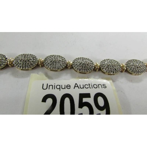 2059 - A 9ct gold and diamond bracelet (missing some diamonds).