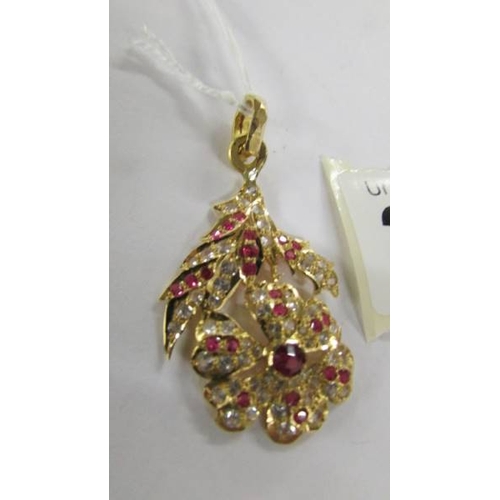 2061 - A stone set floral design pendant (tests as 18ct gold).