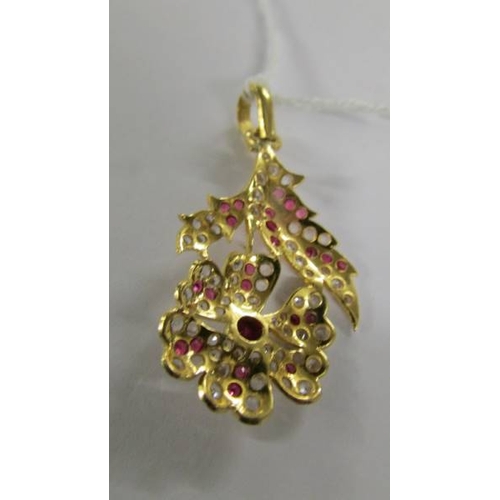 2061 - A stone set floral design pendant (tests as 18ct gold).