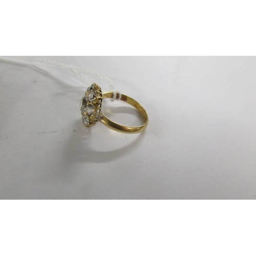 2063 - A cluster ring set clear stones, size O. (tests as 18ct gold).