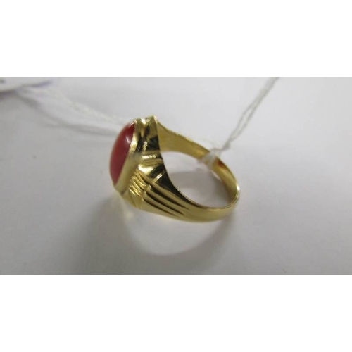 2065 - A ring set red stone, size T. (tests as 18ct gold).