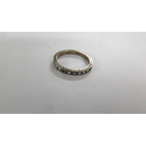 2068 - A silver eternity ring and 2 other rings.