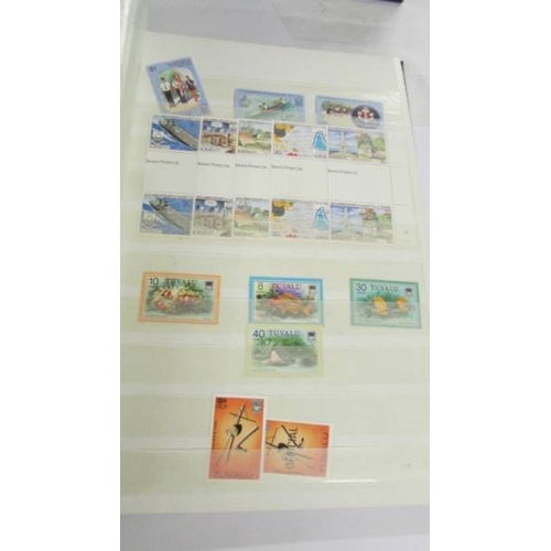 2164 - An album of German postage stamps and three other albums of stamps including Hong Kong, Tuvalu, USA,... 