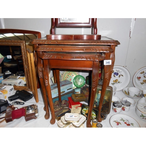 346 - A darkwood nest of tables with green leather inset and glass tops, Height 53.5cm