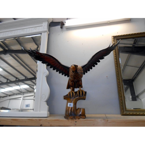 363 - A large wooden figure of an eagle (wings detach as well as base) The bottom has a few minor nibble b... 