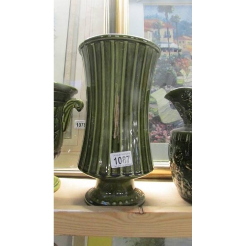 1087 - A green pottery jug, jardiniere and vase.