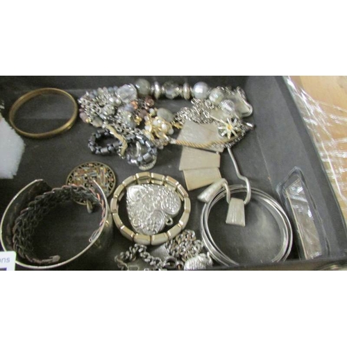 2095 - A large selection of silver coloured metal costume jewellery including rings, cuffs, bangles, neckla... 