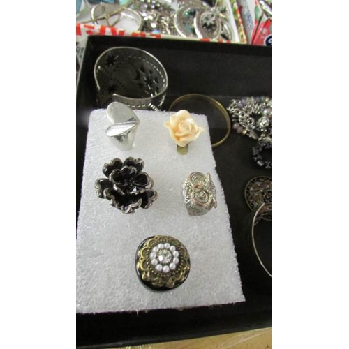 2095 - A large selection of silver coloured metal costume jewellery including rings, cuffs, bangles, neckla... 