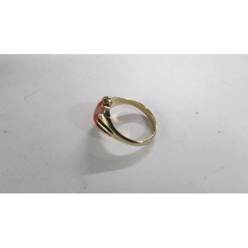 2106 - An early 20th century coral gentleman's ring, stamped 9ct, size T.