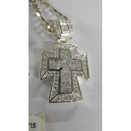 2115 - A heavy quality Italian designed silver cross pendant set with white stones attached to a chain, tot... 