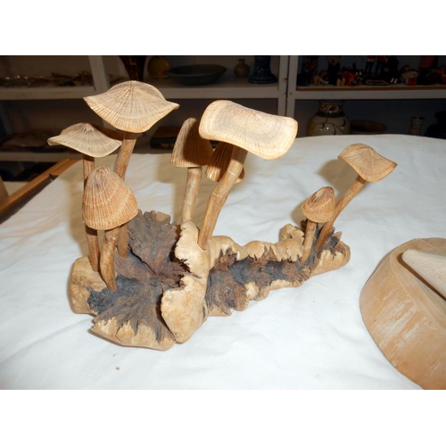 265 - A carved wooden mushroom and bird family displays