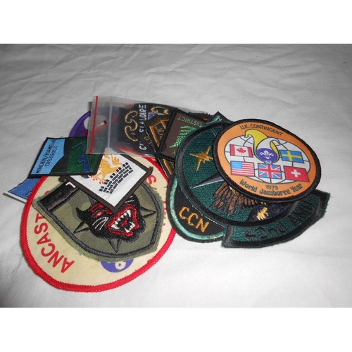 282 - A box of sew on patches including girl guides, plus pin badges, small books (Scottish songs, The Spa... 