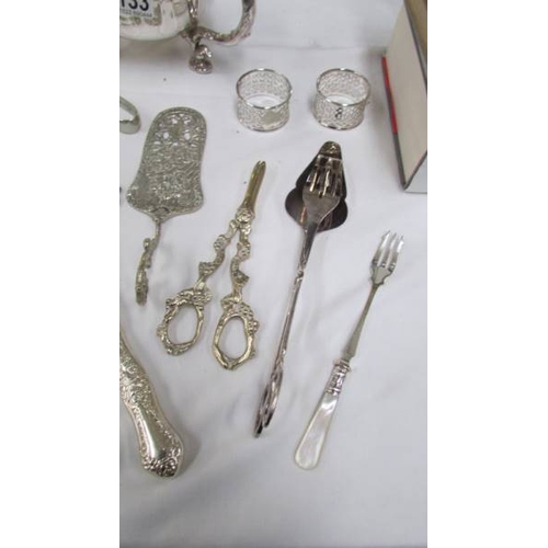 1133 - A silver plate table centrepieces, fish slice, cake slice, salad tongs, grape scissors etc.,