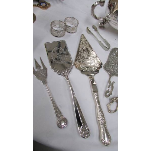 1133 - A silver plate table centrepieces, fish slice, cake slice, salad tongs, grape scissors etc.,