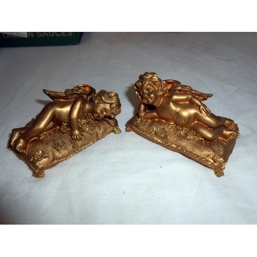 285 - A pair of gilded resin cherub candlesticks, trinket box, marble lion, white metal items, and the lit... 