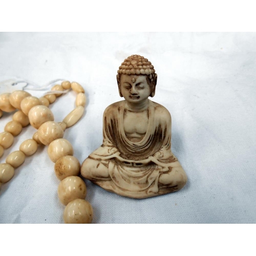 295 - A vintage bone necklace and resin buddah