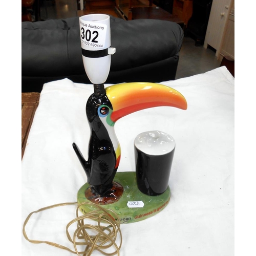 302 - A Carlton Ware Guinness Toucan table lamp, base damaged and repaired, needs re-wiring