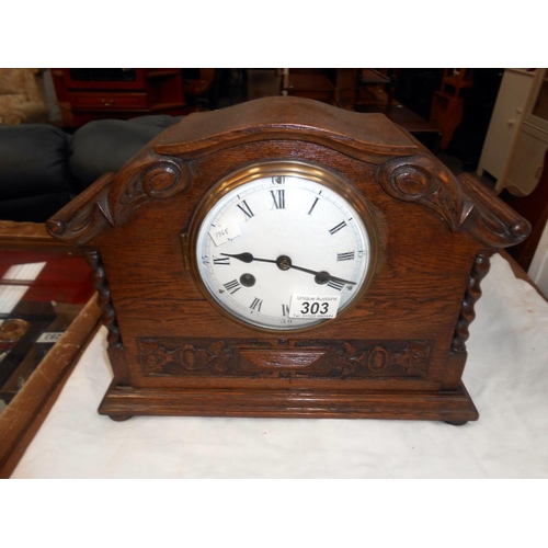 303 - A 1930's oak 8 day mantle clock with enamel dial