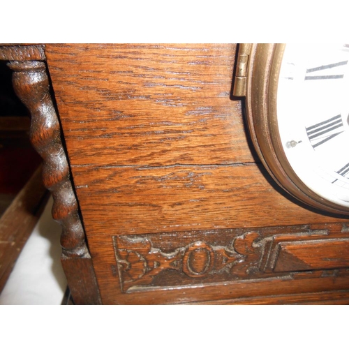 303 - A 1930's oak 8 day mantle clock with enamel dial