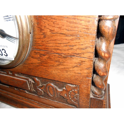 303 - A 1930's oak 8 day mantle clock with enamel dial