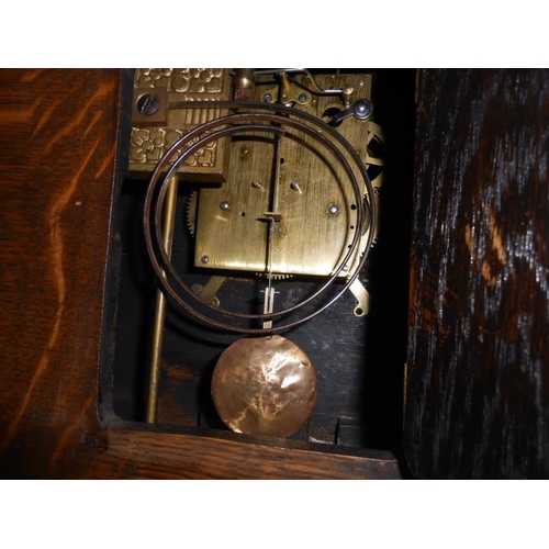 303 - A 1930's oak 8 day mantle clock with enamel dial