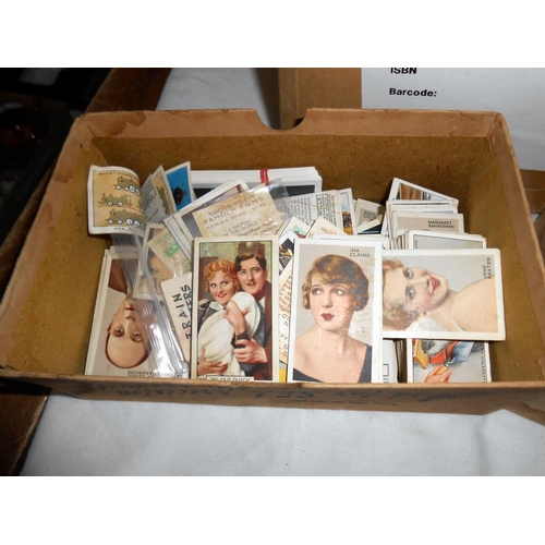 308 - A box of ephemera including vintage postcards and photgraphs, cigarette cards and a quantity of ciga... 