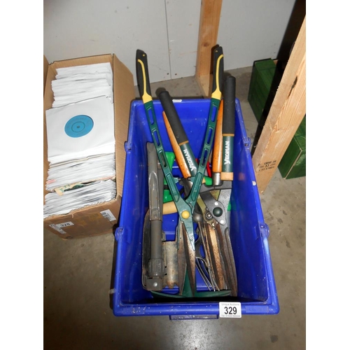 329 - A quantity of garden tools including shears, secateurs etc.