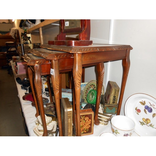 346 - A darkwood nest of tables with green leather inset and glass tops, Height 53.5cm