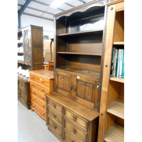 374 - A dark oak drawer based dresser with carved drape panel doors, Height 194cm, width 94.5cm approx.