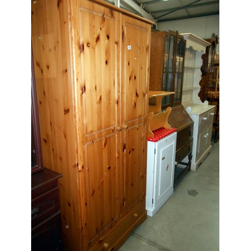 385 - A solid pine 2 door wardrobe (has electric socket for a plug attached and hole in back for a plug to... 