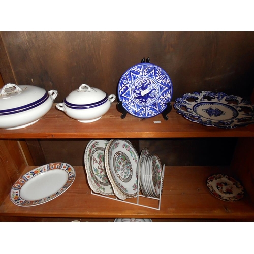 393 - A quantity of blue and white dinner ware including a meat platter and tureens, 1 a/f, plus other din... 