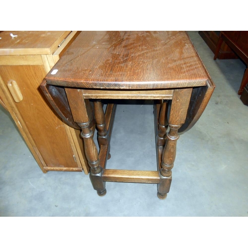 398 - A 1930's oak gateleg table on turned legs, Height 75.8cm, size open 136cm x 114cm, closed 45cm x 114... 