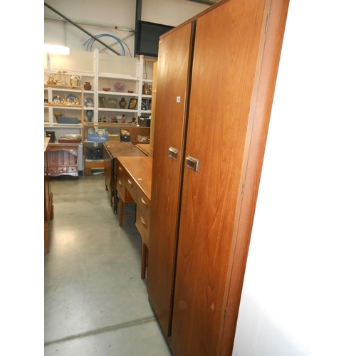 400 - A Gents 2 door teak wardrobe with half hanging on one side and 4 shelves, tie rack, stud holder and ... 