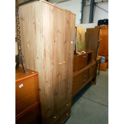 406 - A modern 2 door 2 drawer pine effect wardrobe, height 181cm, width 67cm, approx.