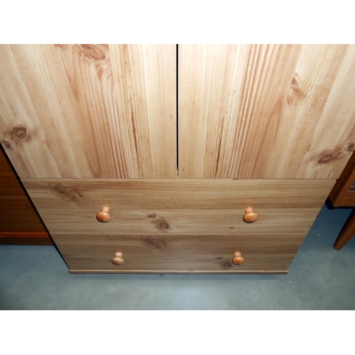 406 - A modern 2 door 2 drawer pine effect wardrobe, height 181cm, width 67cm, approx.