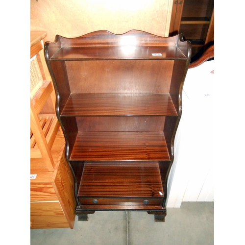 426 - Darkwood stained book shelves with a drawer, height 113cm, width 57cm approx.