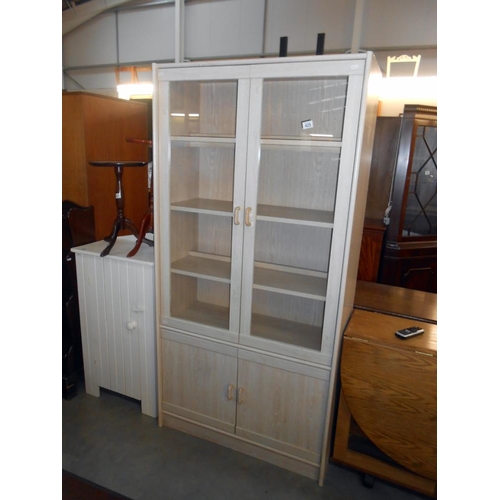 429 - A limed oak effect 2 door 2 cupboard display cabinet bookcase, height 182cm, width 90cm approx.