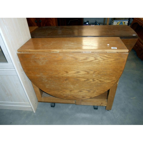 430 - An oak finished dropleaf table with cupboard centre base, height 74.5cm, open 136cm x 86cm, closed 3... 