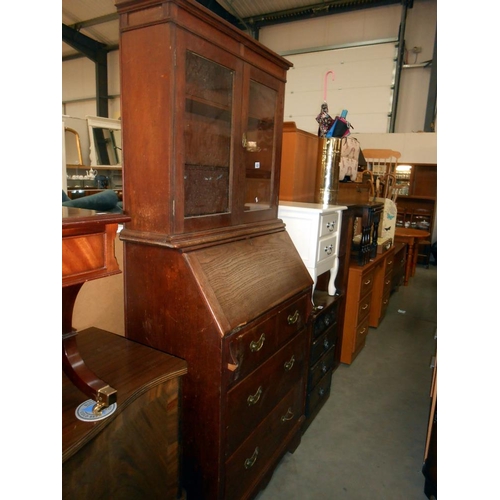 438 - A 1920'30's oak bureau bookcase (lock and escutcheon in drawer and needs to be fixed back on), heigh... 