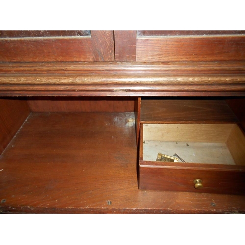 438 - A 1920'30's oak bureau bookcase (lock and escutcheon in drawer and needs to be fixed back on), heigh... 