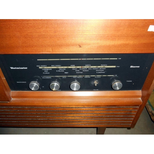 447 - A retro teak effect Westminster record player radio radiogramme, height 66cm, length 117cm approx.