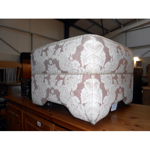 452 - A large fabric covered foot stool on wheels, height 40cm,