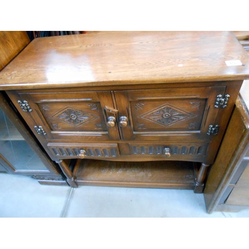 458 - A carved oak 2 drawer 2 cupboard small buffet, height 80cm, width 84cm approx.