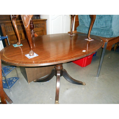 467 - A darkwood stained oval dining table with brass string inlay on centre column, Height 74.5cm, top 92... 