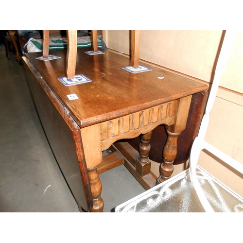 471 - A solid oak gateleg table, height 74cm, open 150cm x 90cm, closed 48cm x 90cm approx.