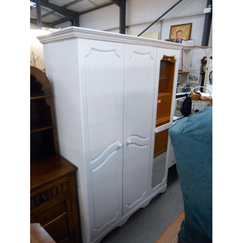 486 - A white melamine 3 door wardrobe with mirrored door, height 199cm, width 136cm approx.