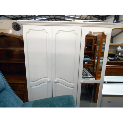 486 - A white melamine 3 door wardrobe with mirrored door, height 199cm, width 136cm approx.