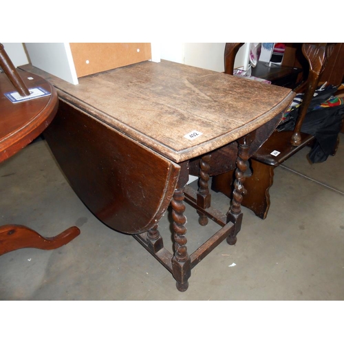 492 - A Victorian oak gateleg table on barley twist legs, Height 72cm, open 156cm x 103cm, closed 52cm x 1... 