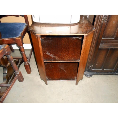 498 - A 1930's oak book table, height 57cm, top 47cm square approx.