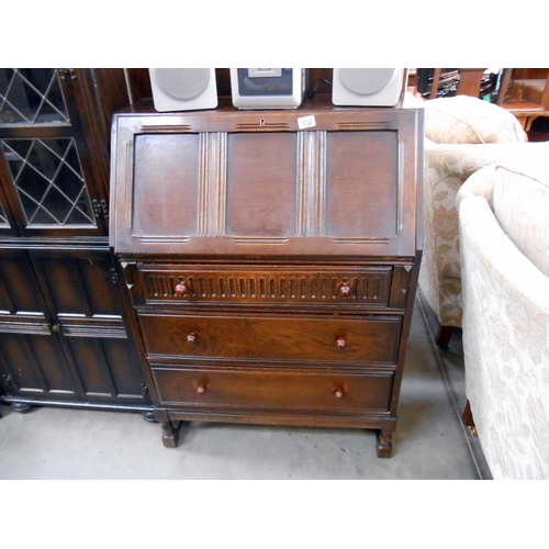 502 - A 1950's oak bureau, height 118cm, width 77cm approx.